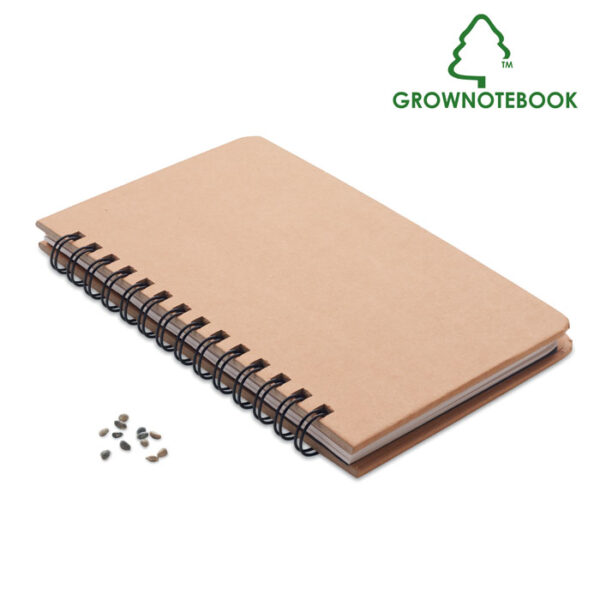 Libreta ecológica GROWNOTEBOOK™ con semillas de pino en la tapa y espiral metálico, ideal para promociones sostenibles con impacto positivo.