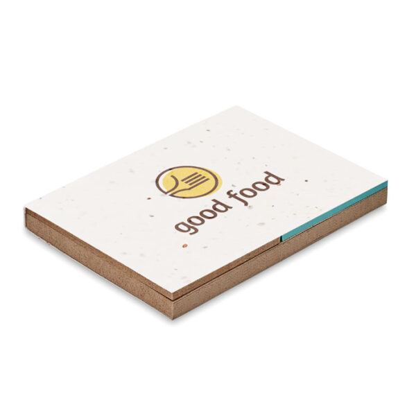 Bloc ecológico con tapa de semillas plantables, papel de hierba y marcadores de colores, ideal para promociones sostenibles y branding responsable.